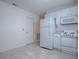 An open kitchen featuring modern appliances and tile flooring at 701 Cottage Park Ln, Leesburg, FL 34748