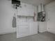 Bright laundry room with washer, dryer, overhead cabinets, and access to the garage at 701 Cottage Park Ln, Leesburg, FL 34748