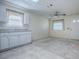 Spacious room featuring soft tile, a ceiling fan, sink and a window with blinds for natural light at 701 Cottage Park Ln, Leesburg, FL 34748