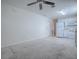 Open layout with neutral living room leading to a kitchen with white appliances and cabinets at 701 Cottage Park Ln, Leesburg, FL 34748