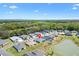 Subdivision aerial shows numerous homes nestled near a pond, with the property location pinpointed at 7250 Trundle Ter, The Villages, FL 34762