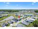 Neighborhood aerial shot highlights a property within a beautifully planned community, near a lake at 7250 Trundle Ter, The Villages, FL 34762
