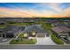 Beautiful single Gathering home featuring lush green lawn, pond view, and attached two car garage at 7250 Trundle Ter, The Villages, FL 34762