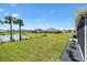 Beautiful backyard with manicured lawn, waterfront view, and tasteful landscaping details at 7250 Trundle Ter, The Villages, FL 34762