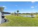 Expansive backyard with lush lawn and peaceful lake views, perfect for outdoor enjoyment at 7250 Trundle Ter, The Villages, FL 34762