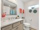 Well-lit bathroom featuring a vanity with a quartz countertop, and coastal-themed decor at 7250 Trundle Ter, The Villages, FL 34762