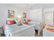 Bright bedroom featuring two beds, beach-themed decor, and a closet for ample storage at 7250 Trundle Ter, The Villages, FL 34762