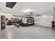 Spacious garage with epoxy flooring, ample storage, and parking for multiple vehicles and a golf cart at 7250 Trundle Ter, The Villages, FL 34762