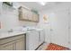 Functional laundry room with modern washer and dryer, ample storage, and stylish accents at 7250 Trundle Ter, The Villages, FL 34762