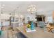 Open-concept living space seamlessly connects kitchen, dining, and living areas, creating a modern and inviting atmosphere at 7250 Trundle Ter, The Villages, FL 34762
