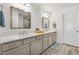 Elegant main bathroom featuring double sinks, quartz countertops, and modern fixtures, offering a spa-like experience at 7250 Trundle Ter, The Villages, FL 34762