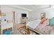 Well-lit main bedroom with carpet, a calm atmosphere, and convenient access to the main bathroom at 7250 Trundle Ter, The Villages, FL 34762