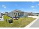 Well-manicured lawn and landscaping highlight this single Gathering home with a side entry three car garage at 7250 Trundle Ter, The Villages, FL 34762