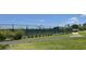 Well-maintained tennis courts within a community, surrounded by green landscape and walking paths at 7250 Trundle Ter, The Villages, FL 34762
