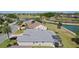 Aerial view of home with screened lanai backing onto a lake and golf course at 749 Aberdeen Run, The Villages, FL 32162