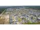 Expansive aerial view showcases the community layout with homes, ponds, and landscaping at 7539 Hagemeyer Pl, The Villages, FL 34762
