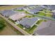 Aerial view highlights screened lanai, fenced yard, and patio with hot tub and furniture at 7539 Hagemeyer Pl, The Villages, FL 34762
