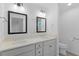 Well-lit bathroom with dual sinks, modern fixtures, and a handicap rail at 7539 Hagemeyer Pl, The Villages, FL 34762
