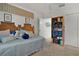 Bedroom features a decorative headboard, plush carpet, and white walls at 7539 Hagemeyer Pl, The Villages, FL 34762
