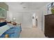 Bedroom with carpeted floors, large closet, and view to the hallway at 7539 Hagemeyer Pl, The Villages, FL 34762