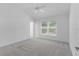 Carpeted bedroom featuring vaulted ceiling and window with blinds at 7539 Hagemeyer Pl, The Villages, FL 34762
