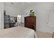 Bedroom features a vanity and storage cabinet with a television on top at 7539 Hagemeyer Pl, The Villages, FL 34762