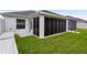 Exterior view of screen enclosed porch and well maintained lawn at 7539 Hagemeyer Pl, The Villages, FL 34762