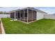 Exterior view of screen enclosed porch with tidy yard and landscaping at 7539 Hagemeyer Pl, The Villages, FL 34762