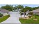 Charming single-story home with a two-car garage, well-maintained lawn, and attractive landscaping at 7539 Hagemeyer Pl, The Villages, FL 34762