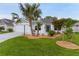 Charming single-story home featuring a manicured lawn with rock landscaping, a palm tree and a spacious two car garage at 7539 Hagemeyer Pl, The Villages, FL 34762