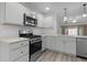 Modern kitchen with stainless steel appliances and white countertops at 7539 Hagemeyer Pl, The Villages, FL 34762