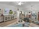 Bright living room featuring modern furniture, a ceiling fan, and a view to the dining area and front of the house at 7539 Hagemeyer Pl, The Villages, FL 34762