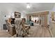 Bright living room featuring vaulted ceiling, luxury vinyl flooring, and sliding glass doors to patio at 7539 Hagemeyer Pl, The Villages, FL 34762