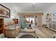 Comfortable living room featuring stylish furnishings and sliding glass doors to screened in patio at 7539 Hagemeyer Pl, The Villages, FL 34762