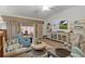 Bright living room featuring modern furniture, a ceiling fan, and sliding glass doors to the screened-in lanai at 7539 Hagemeyer Pl, The Villages, FL 34762