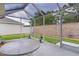 Covered patio featuring serene views of manicured lawn and privacy wall at 7539 Hagemeyer Pl, The Villages, FL 34762