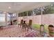Bright sunroom featuring large windows, neutral tile floor, colorful area rugs, and seating for a peaceful retreat at 7539 Hagemeyer Pl, The Villages, FL 34762