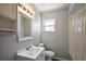 A pristine bathroom with a large vanity, mirror, and a tiled shower behind a translucent curtain at 900 Maple Ave, Fruitland Park, FL 34731