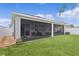 Spacious screened-in patio overlooking a manicured lawn with a privacy fence at 916 Carmillion Ct, Groveland, FL 34736