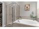 This bathroom features a soaking tub with tile surround and glass shower enclosure at 916 Carmillion Ct, Groveland, FL 34736