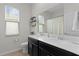 Bathroom features a double vanity and shower at 916 Carmillion Ct, Groveland, FL 34736