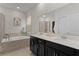Bright bathroom features a double vanity, soaking tub and shower with tile surround at 916 Carmillion Ct, Groveland, FL 34736