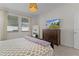 Comfortable bedroom with a dresser, a view of the home on the tv, and large windows offering plenty of natural light at 916 Carmillion Ct, Groveland, FL 34736