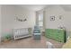 Bedroom features a crib, changing table and window at 916 Carmillion Ct, Groveland, FL 34736