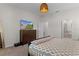 Inviting bedroom showing a dresser with a TV and a view of an ensuite bathroom for added privacy and convenience at 916 Carmillion Ct, Groveland, FL 34736