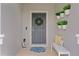 Inviting front entrance features a wreath, plants, welcome mat, and bench seating at 916 Carmillion Ct, Groveland, FL 34736