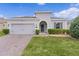 Charming home featuring a paver driveway, attached garage, and well-maintained landscaping at 916 Carmillion Ct, Groveland, FL 34736