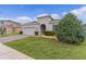 Charming home featuring a paver driveway, attached garage, and well-maintained landscaping at 916 Carmillion Ct, Groveland, FL 34736