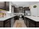 Beautiful kitchen with dark cabinets, stainless steel appliances, white countertops, and modern fixtures throughout the space at 916 Carmillion Ct, Groveland, FL 34736