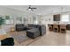 Open-concept living room with large sectional sofa and views of the kitchen and dining area at 916 Carmillion Ct, Groveland, FL 34736